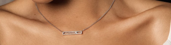 A woman showcases a gold necklace featuring a stunning diamond pendant, highlighting her investment in gold jewellery