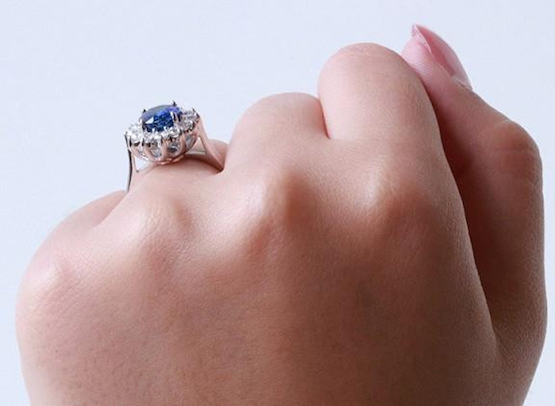 close-up of a hand showcasing a ring featuring a beautiful blue sapphire stoneWith its intense blue appearance, the sapphire is perfect as an accent for an engagement ring. Wedding jewellery with sapphires has gained popularity since Kate Middleton was gi