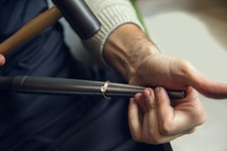 Close-up of a jeweller resizing a brilliant-cut diamond ring.