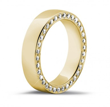 0.70 carat eternity ring in yellow gold with small round diamonds on the side