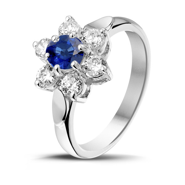 an entourage engagement ring with a sapphire surrounded by white diamonds 