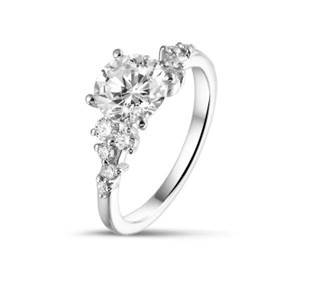 a 1 carat solitaire cluster engagement ring in white gold characterised by a round white diamond