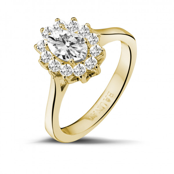 a stunning engagement ring with a yellow gold band and a centre diamond surrounded by smaller diamonds