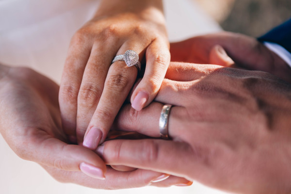 Engaged couple wearing diamond engagement ring - Engaged couple wearing diamond engagement ring