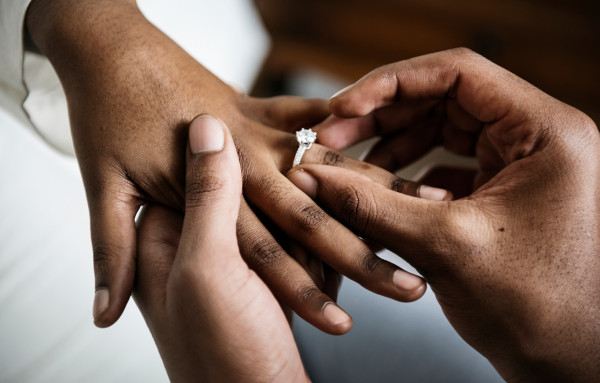 a groom gifting his bride a 1 carat diamond engagement ring as part of chinese wedding culture