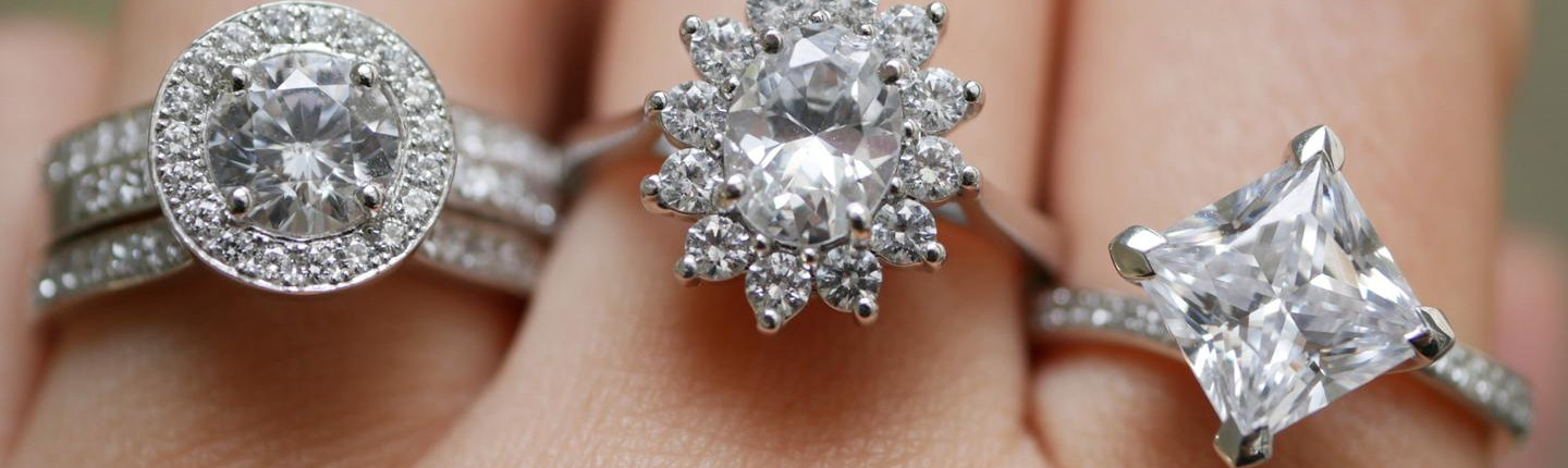 Woman wears several engagement rings from BAUNAT