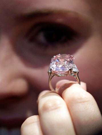 A woman holding the Centenary Diamond of the Beers, which is often referred to as world’s most perfect diamond thanks to its cut and purity - Pink Diamond