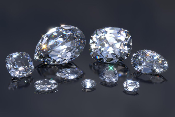 Image of nine Cullinan diamonds, cut from the world's largest diamond - BAUNAT - sparkling Cullinan diamond set against a dark background with dazzling diamonds