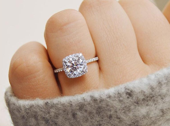 close-up of a woman's hand with a stunning natural diamond engagement ring