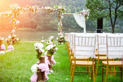 chairs and flowers at a picturesque outdoor wedding ceremony during summer
